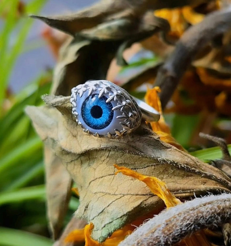 Eyeball ring with blue gemstone on a leaf