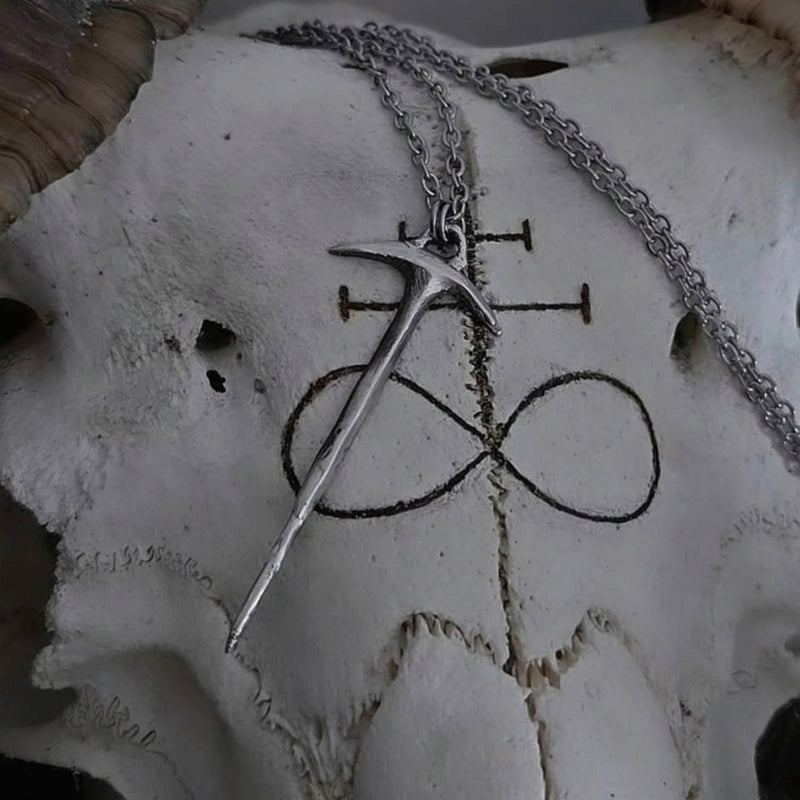 Silver pendant with a symbol on a skull
